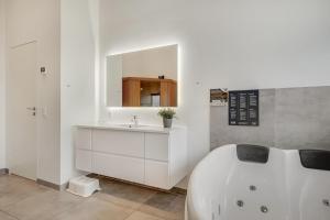 a white bathroom with a tub and a sink at Hedevang 22 Houstrup in Nørre Nebel +39 photos