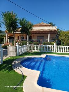 a swimming pool in front of a house at Cortijo del carmen in Moratalla