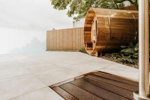 a patio with a wooden fence and a wooden floor at Sauna cottage in Tielt