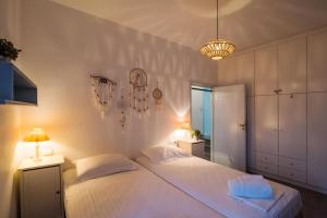 a bedroom with a large bed and a clock on the wall at Villa Allegra in Kythira