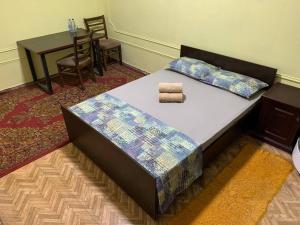 a bed with two pillows on it in a room at AviaHostel in Tashkent International Airport +19 photos