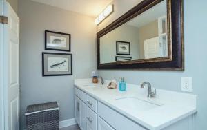 a bathroom with two sinks and a mirror at Oceanfront Two Bedroom Condo with Panoramic Views in Neptune Beach