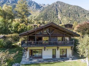 a large house with a balcony on a mountain at Chalet authentique près de Chamonix avec jardin et parking - FR-1-343-182 in Chamonix-Mont-Blanc