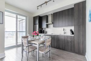 a kitchen with a table with flowers on it at Luxury 1BR Suite w Skyline City Views - The Roland in Toronto