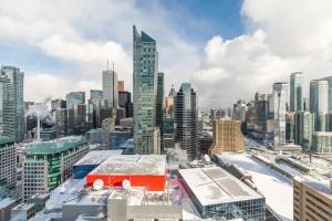 a view of a city with a red bus on the roof at Luxury 1BR Suite w Skyline City Views - The Roland in Toronto