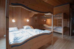a bedroom with two bunk beds in a wooden room at Bakkebyvegen 13B in Trysil +10 photos