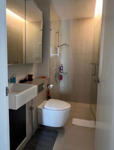 a bathroom with a toilet and a sink and a shower at Lumi Tropicana Unique Deals in Kota Damansara