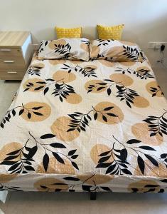 a bed with a black and white comforter and pillows at Lumi Tropicana Unique Deals in Kota Damansara +28 photos