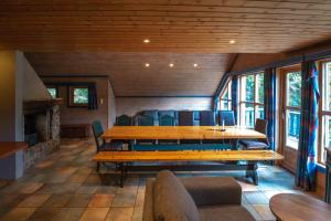 a dining room with a large wooden table and chairs at Bakkebyvegen 13A in Trysil +14 photos