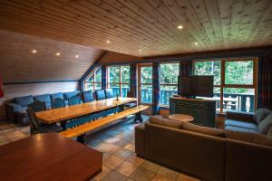 a living room with a wooden table and chairs at Bakkebyvegen 13A in Trysil