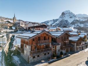 an old house in the mountains with snow on the roofs at Chalet haut de gamme proche des pistes avec sauna et parking privé - FR-1-344-1209 in Saint-Martin-de-Belleville