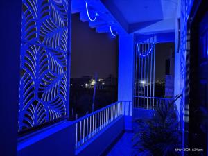 a room with a blue light on a balcony at Shree Datt Yatri Niwas Akkalkot in Solapur +29 photos