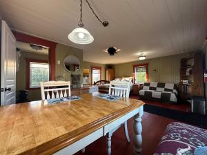 a living room with a wooden table and chairs at La laiterie in Ham Nord