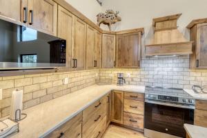 a kitchen with wooden cabinets and a stove at Shadow Pines Lodge in Kirk +30 photos