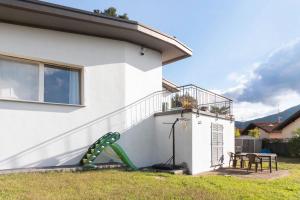 a house with a slide in the yard at Il Gelsomino in Porto Ceresio