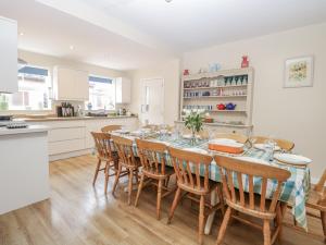 a kitchen and dining room with a table and chairs at Beach House in Winterton-on-Sea