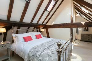 Un dormitorio con una cama grande con almohadas rojas. en 12A College Hill by Sleep Shrewsbury, en Shrewsbury