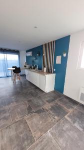 a kitchen with a counter and a table in a room at " Bulles et Evasion - Maison, Spa en option" in Ville-le-Marclet