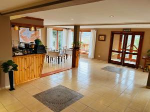 a living room with a kitchen and a dining room at Hotel Koi Mahik in El Calafate