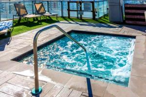 a hot tub with a metal rail in a building at Oceanfront Retreat Steps from Hollywood Beach in Hollywood Beach