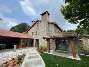 an exterior view of a stone house at In Secreto in Dunières