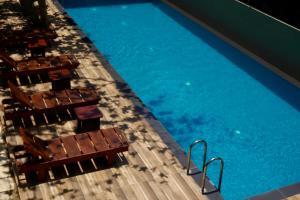 an overhead view of a swimming pool with chairs at NatureSurf Villas - Private Garden Retreat at Hiriketiya Beach SPA, Surf & Relaxation in Dickwella