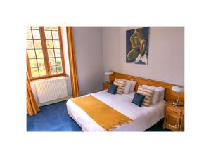 ein Schlafzimmer mit einem großen Bett mit zwei Fenstern in der Unterkunft Gites Aubelle - La Maison Aubelle in Montreuil-Bellay + 43 Fotos