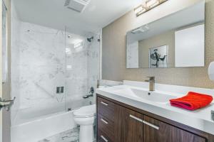 a bathroom with a sink and a toilet and a shower at Oceanfront Three Bedroom Condo with Panoramic View in Pompano Beach