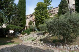 a garden with stone steps in front of a building at Cittadella Laudato Si' in Assisi