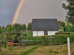 a rainbow over a white house with at Alice in Altenfeld