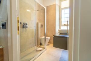 a bathroom with a shower and a toilet and a sink at Apartment Next to St Peter in Rome