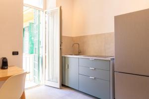 a kitchen with a sink and a refrigerator at Apartment Next to St Peter in Rome