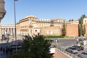 a busy city street with a large building in the background at Apartment Next to St Peter in Rome