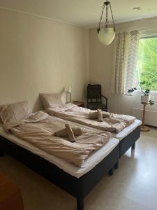 a large bed with two pillows on it in a bedroom at Mysighem Hembackavägen 13 in Vaasa