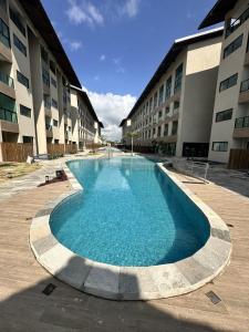 a large swimming pool in front of a building at Studio Premium Praia dos Carneiros in Tamandaré