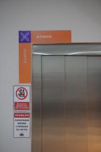 a metal refrigerator with a sign next to it at Hotel Portal dos Cerrados in Uruçuí