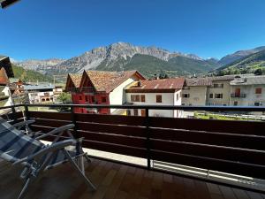 a balcony with a chair and a view of mountains at Appartamento Tasso in Santa Lucia