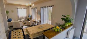 a dining room and living room with a table and chairs at patra's sea front apartment in Flámbouras