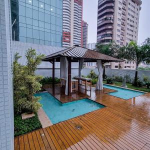 a wooden deck with a gazebo in the rain at Ap 2 Quartos na Doca em Prédio de Luxo in Belém