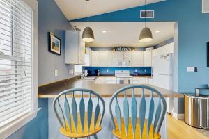 two chairs in a kitchen with blue walls at Temptation #40HC4 in Avon +19 photos