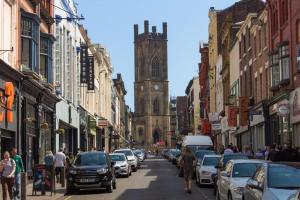 a city street with a clock tower and cars parked at Entire Aparthotel Bold St 8 Apartments in Liverpool