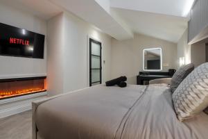 a bedroom with a bed and a fireplace at Entire Aparthotel Bold St 8 Apartments in Liverpool