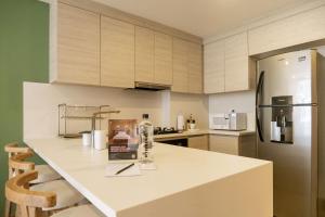 a kitchen with a white counter and a refrigerator at Minimalist 1BR Amazing View in Morros Eos in Cartagena de Indias