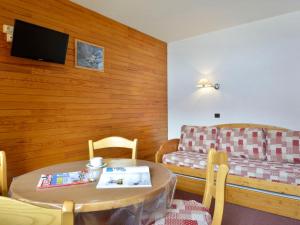 a living room with a table and a couch at Studio agréable près des pistes avec balcon - FR-1-181-2356 in La Plagne Tarentaise