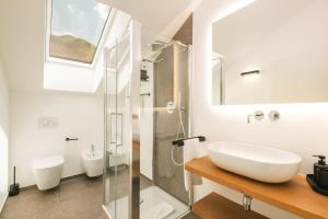 a bathroom with a sink and a glass shower at Maso Renner in Laives +288 photos