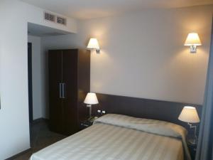 Postel nebo postele na pokoji v ubytování Hotel Le Badie