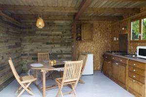 a kitchen with a table and chairs in a room at Le Clos De La Combe in Saint-Jean-dʼOrbetiers