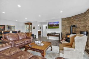 a living room with leather furniture and a fireplace at Family Mountain Escape w Private Suite Modern Comforts in Old Fields