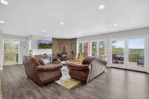a living room with leather furniture and a fireplace at Family Mountain Escape w Private Suite Modern Comforts in Old Fields +68 photos