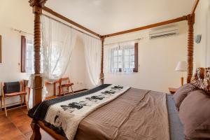 a bedroom with a canopy bed in a room at 3-bedroom Villa in Golf del Sur in San Miguel de Abona +25 photos